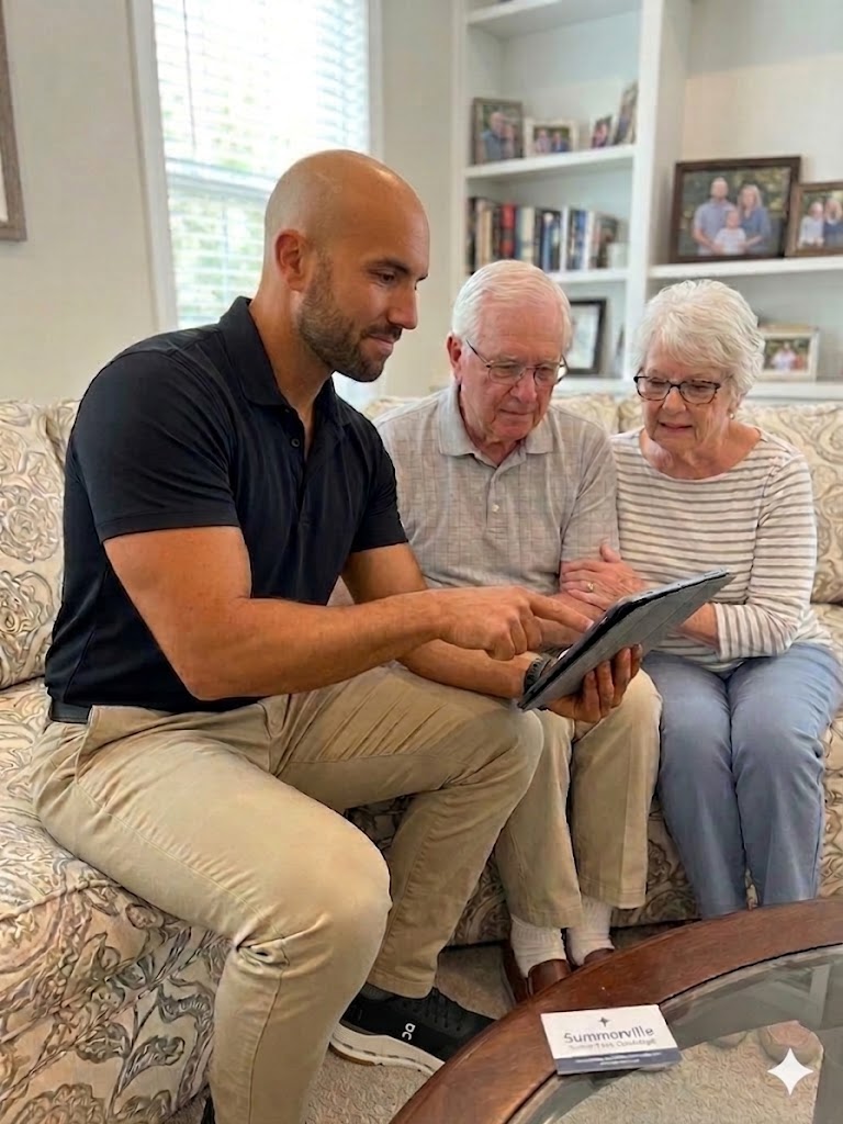 A Summerville Tech Concierge technician patiently helping an older couple with their tablet in their home